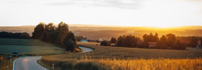 Sunset city road in the field, sun, evening